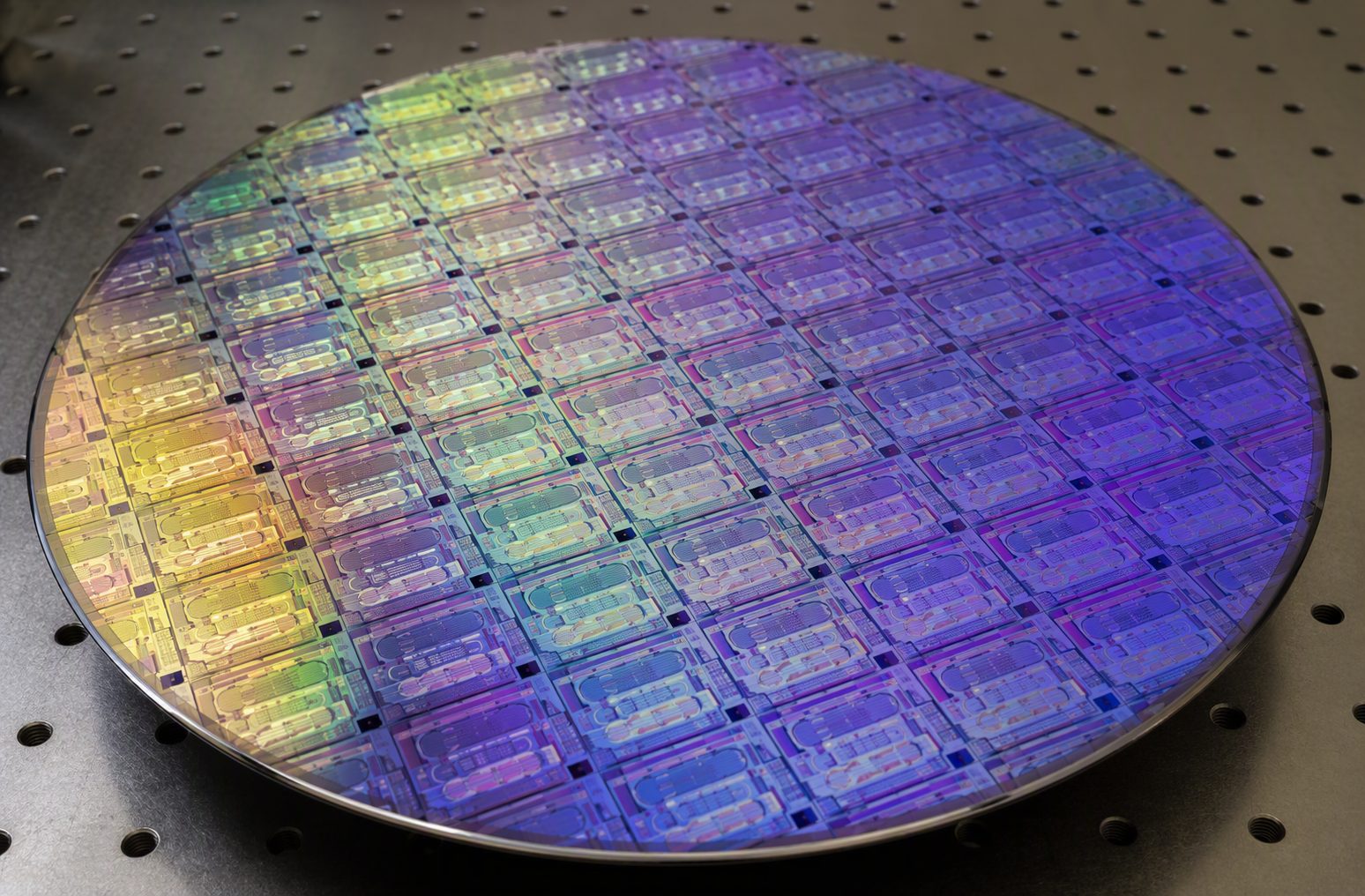 Close-up of a photonic wafer with an iridescent grid of chips